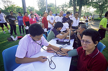 People receiving free medical check-ups in Lumphini Park, Bangkok, Thailand, Southeast Asia, Asia