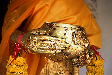 Detail of Buddha statue showing alms bowl covered in gold leaf, Nakhon Pathom Chedi, Nakhon Pathom, Thailand, Southeast Asia, Asia