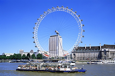 London Eye and River Thames with tour boat, London, England, United Kingdom, Europe