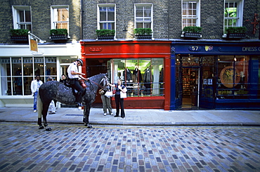 Mounted policeman in Monmouth Street, Soho, London, England, United Kingdom, Europe