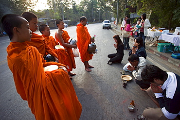 Monks receiving offerings of food, Chiang Mai, Thailand, Southeast Asia, Asia