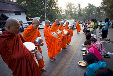 Monks receiving offerings of food, Chiang Mai, Thailand, Southeast Asia, Asia