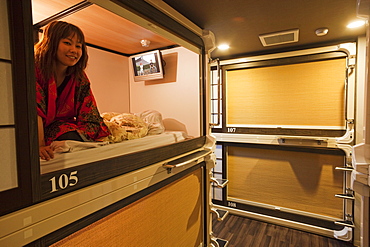 Girl in room, Capsule Ryokan Kyoto Hotel, Kyoto, Japan, Asia