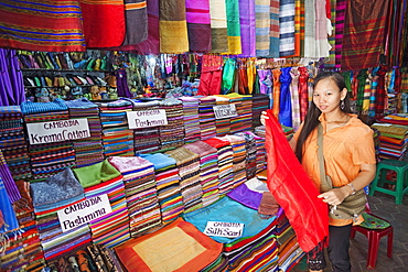 Shop assistant in material and silk shop, The Old Market, Siem Reap, Cambodia, Indochina, Southeast Asia, Asia