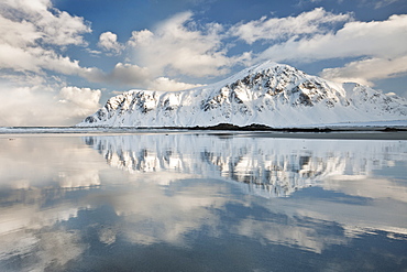 Morning light hits a mountain on the beach of Flakstad, Flakstadoya, Lofoten Islands, Arctic, Norway, Scandinavia, Europe