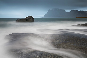 Water breaks over rocks at Uttakleiv, Lofoten Islands, Arctic, Norway, Scandinavia, Europe