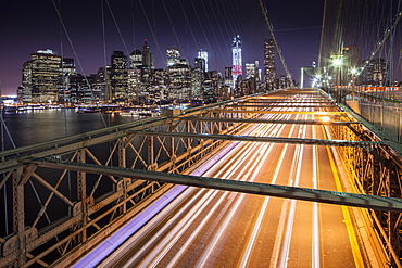 Traffic leaves colourful trails along the Brooklyn Bridge in New York, New York State, United States of America, North  America