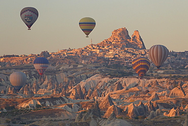 Hot air balloons rising into the dawn sky above Goreme, Cappadocia, Anatolia, Turkey, Asia Minor, Eurasia