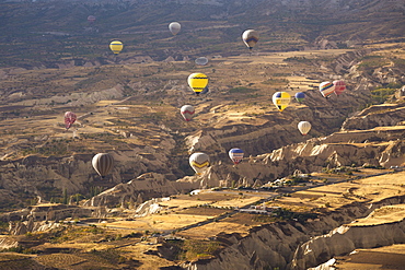 Hot air balloons above the volcanic landscape near Goreme, Cappadocia, Anatolia, Turkey, Asia Minor, Eurasia