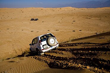 Photograph of SUV's in the Jordanian desrt