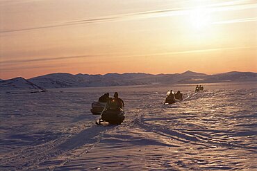 Image of a convoy of motorbikes on the ice plains of Baffin Canada