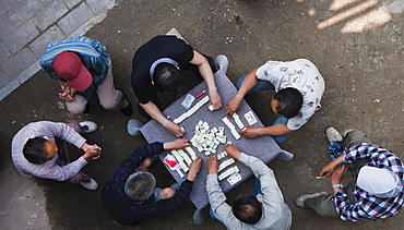 Overhead view of Chinese men sitting outdoors playing the traditional game of mahjong, Hangzhou, China, Asia