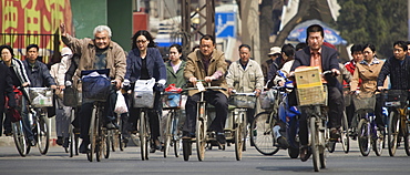 Chinese commuters riding bicycles on a city street, Beijing, China, Asia