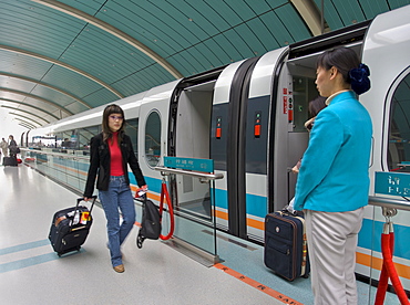 Passenger boarding magnetic levitation high speed train on a Shanghai station platform, Shanghai, China, Asia