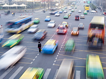 Overhead view of morning commute traffic on a busy Chinese city street with pedestrians and blurred vehicles, Chengdu, Sichuan, China, Asia