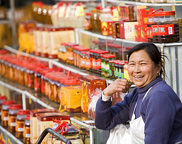 Chinese female street vendor selling packaged food and gift products, Chengdu, Sichuan, China, Asia