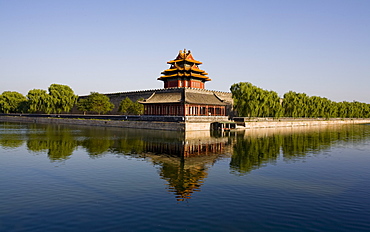 The northwest corner tower and water filled moat surrounding The Forbidden City, Beijing, China, Asia