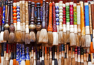 Chinese calligraphy brushes with colorful handcarved handles of stone and wood, Beijing, China, Asia