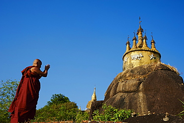 Buddhist monk praying at the Golden Rock of Nwa La Bo, Mawlamyine (Moulmein), Mon State, Myanmar (Burma), Asia