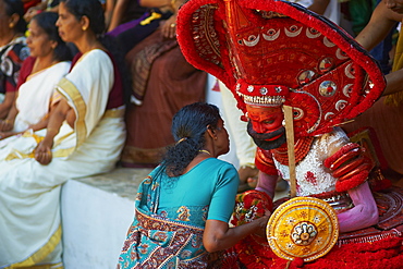 Man in costume representing a god at the Teyyam ceremony, near Kannur, Kerala, India, Asia