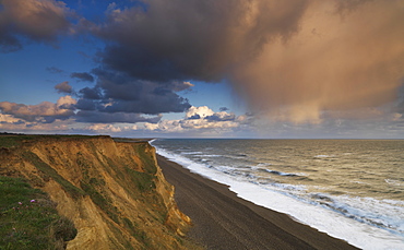 A rain cloud approaches the cliffs at Weybourne, Norfolk, England