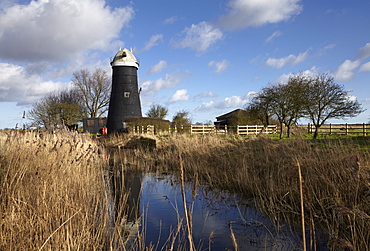 A bright winter day in the Norfolk Broads showing Tall Mill near Upton, Norfolk, England, United Kingdom, Europe