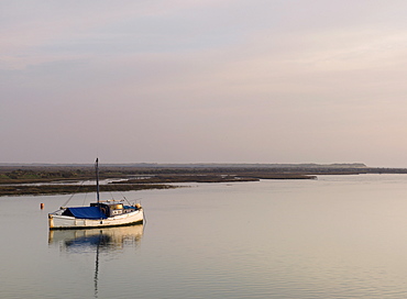 A loan boat in the tidal channel at Burnham Overy Staithe, Norfolk, England, United Kingdom, Europe