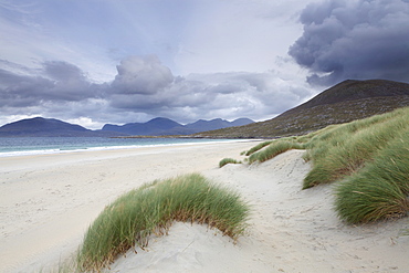 The mountains of North Harris loom large behind Luskentyre Bay, Isle of Harris, Outer Hebrides, Scotland, United Kingdom, Europe