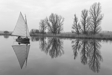 A sailing boat on the River Bure at St. Benets Abbey, Norfolk, England, United Kingdom, Europe