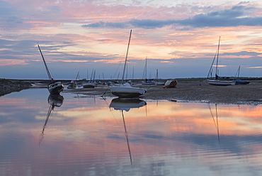 Sunset over the tidal channel at Brancaster Staithe, Norfolk, England, United Kingdom, Europe