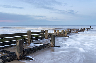 Incoming waves hitting a groyne at Walcott, Norfolk, England, United Kingdom, Europe