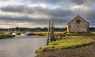 A view of boats moored in the creek at Thornham, Norfolk, England, United Kingdom, Europe