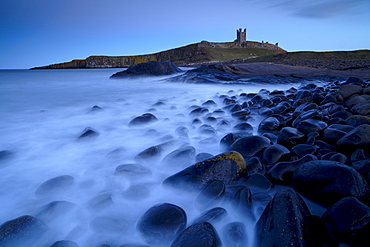 Dusk on the shoreline at Dunstanburgh, Northumberland, England, United Kingdom, Europe