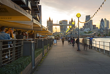 Tower Bridge and City of London skyline from Butler's Wharf at sunset, London, England, United Kingdom, Europe