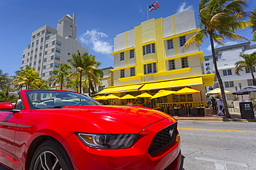 Art Deco architecture and red sports car on Ocean Drive, South Beach, Miami Beach, Miami, Florida, United States of America, North America