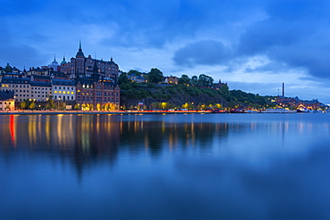 Skyline of Sodermalm at dusk reflection in water, Stockholm, Sweden, Scandinavia, Europe