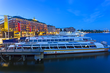 The Grand Hotel and sightseeing boats at dusk, Stockholm, Sweden, Scandinavia, Europe