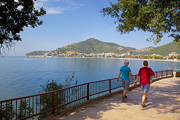 Walkers and Old Town, Budva Bay, Montenegro, Europe