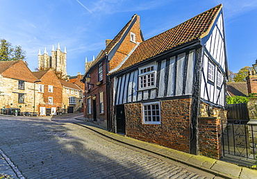 Lincoln Cathedral and timbered architecture viewed from the cobbled Steep Hill, Lincoln, Lincolnshire, England, United Kingdom, Europe