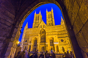 Lincoln Cathedral viewed through archway of Exchequer Gate at dusk, Lincoln, Lincolnshire, England, United Kingdom, Europe