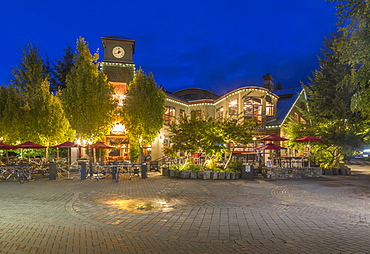 Illuminated shops on Village Stroll at dusk, Whistler, British Columbia, Canada, North America