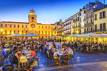 View of cafes and Torre Dell'Orologio in Piazza dei Signori at dusk, Padua, Veneto, Italy, Europe