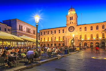 View of cafes and Torre Dell'Orologio in Piazza dei Signori at dusk, Padua, Veneto, Italy, Europe