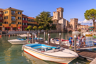 View of Scaliger Castle and boats in harbour, Sirmione, Lake Garda, Lombardy, Italian Lakes, Italy, Europe