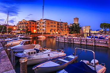 View of Scaliger Castle and boats in harbour at dusk, Sirmione, Lake Garda, Lombardy, Italian Lakes, Italy, Europe