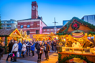 View of visitors and Christmas Market stalls at Christmas Market, Millennium Square, Leeds, Yorkshire, England, United Kingdom, Europe