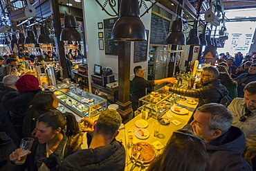 Hustle and bustle of the interior of San Miguel Market, Madrid, Spain, Europe