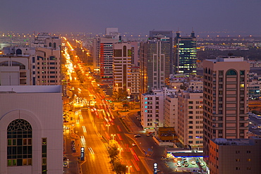 City skyline and Rashid Bin Saeed Al Maktoum Street at dusk, Abu Dhabi, United Arab Emirates, Middle East 