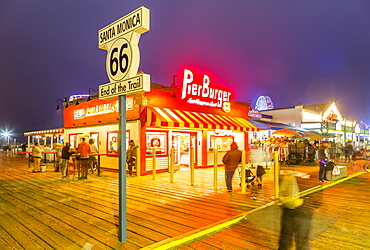 View of shops and Route 66 End of Trail sign on Santa Monica Pier, Santa Monica, Los Angeles, California, United States of America, North America