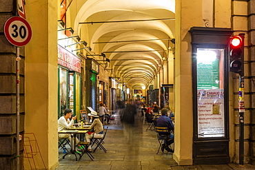 View of Cafe under the arches in shopping arcade at dusk, Turin, Piedmont, Italy, Europe